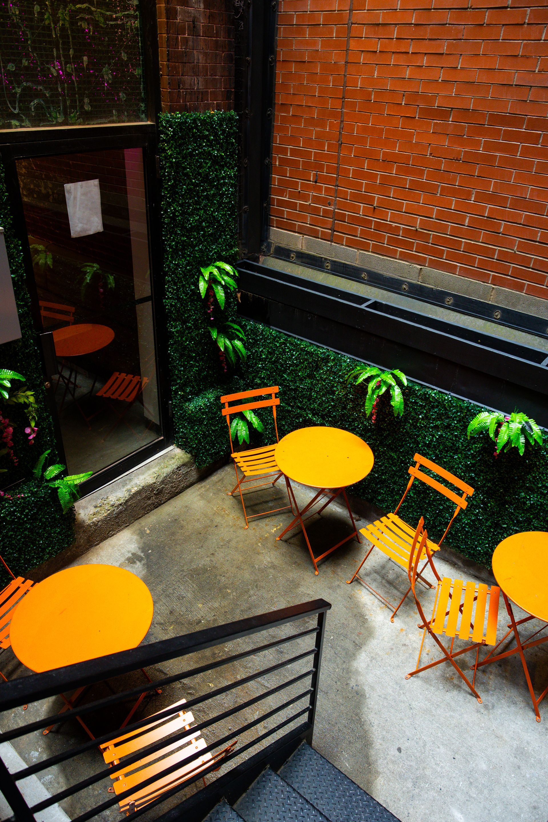 An aerial view of a courtyard with yellow tables and chairs