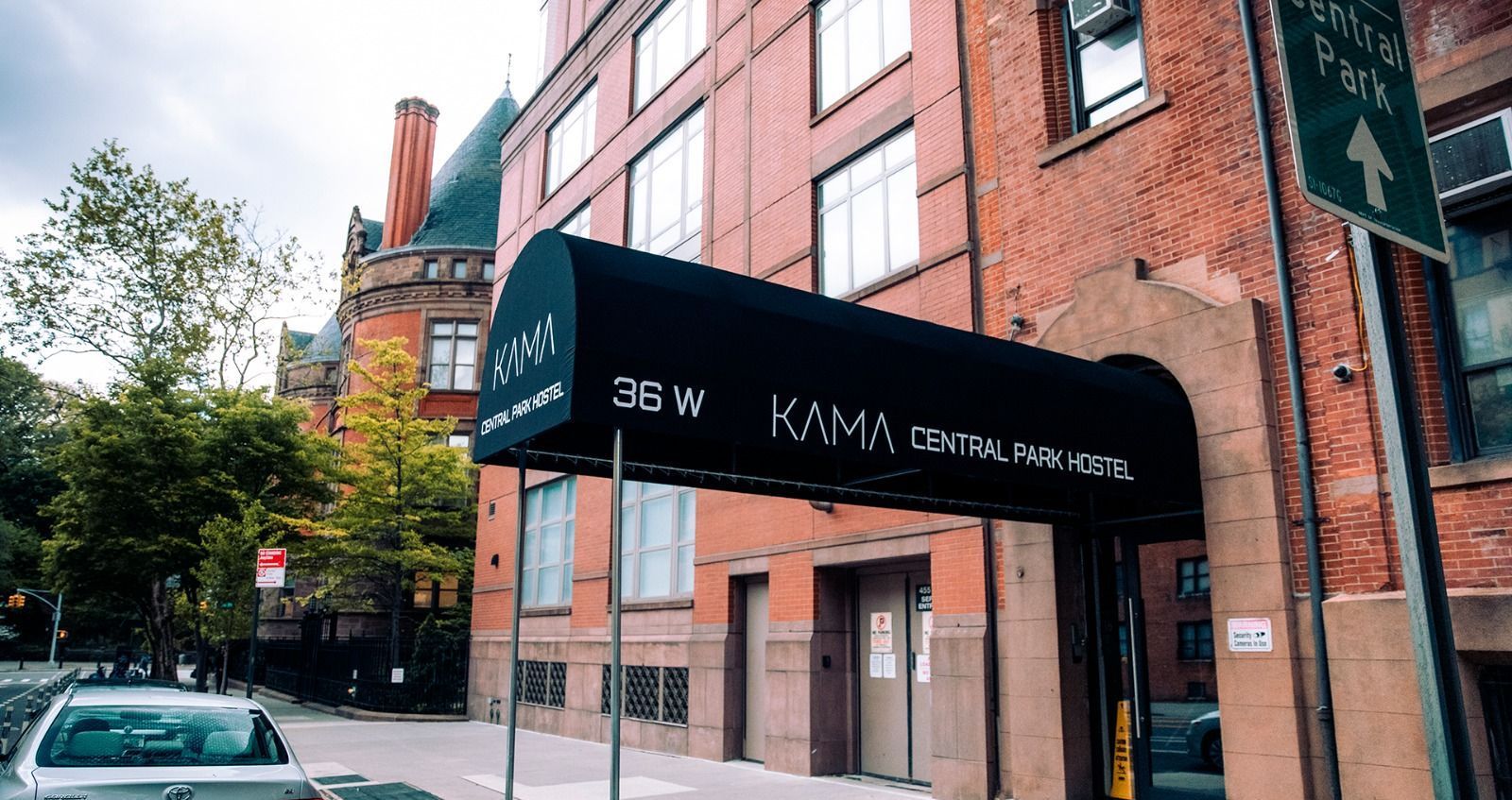 A brick building with a black awning over the entrance