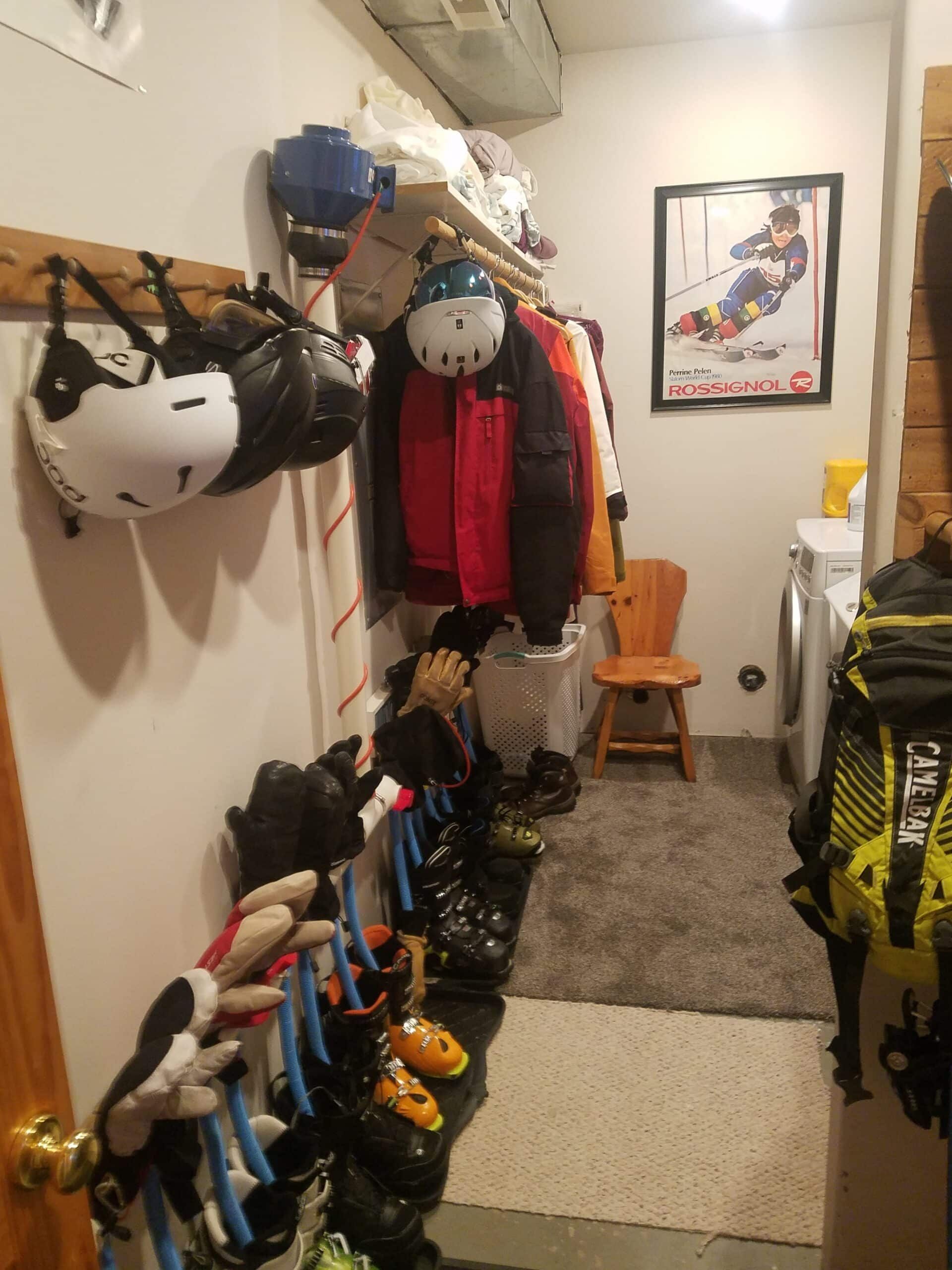 A laundry room with a lot of clothes hanging on the wall.