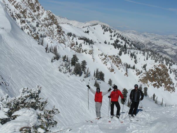 A group of people skiing down a snowy mountain