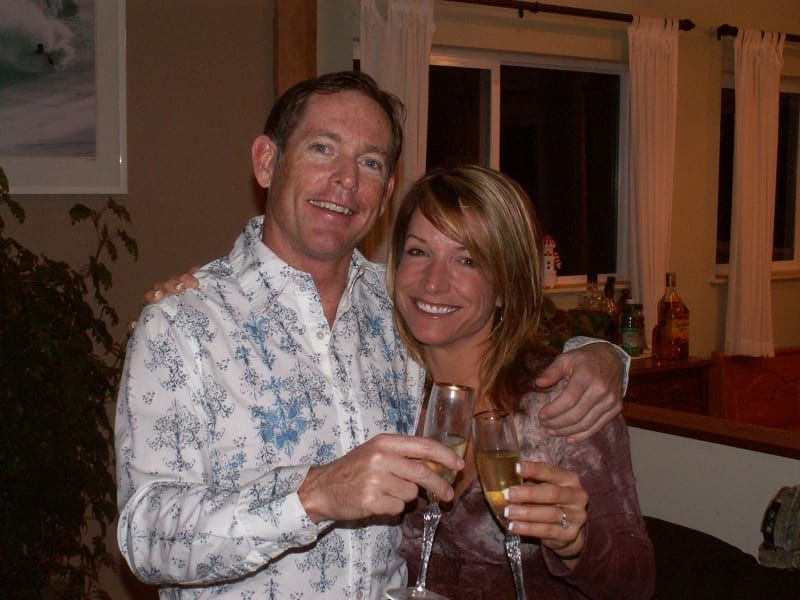 A man and a woman toasting with wine glasses