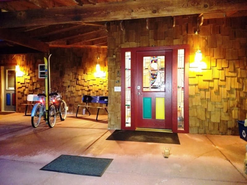A bicycle is parked in front of a red door