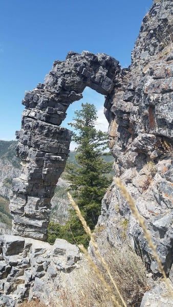 A stone archway in the middle of a rocky cliff