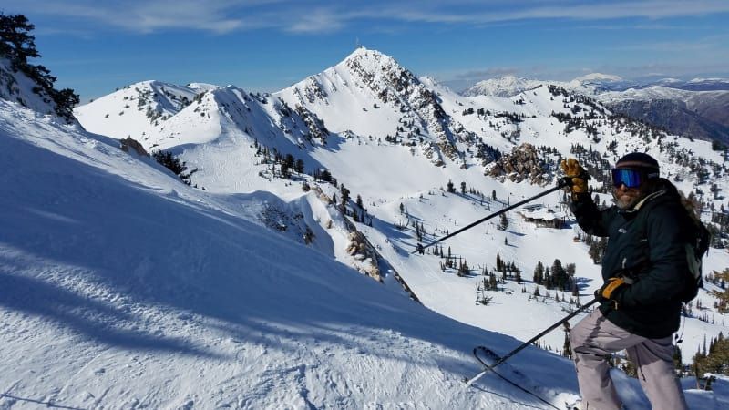 A person is skiing down a snow covered mountain.