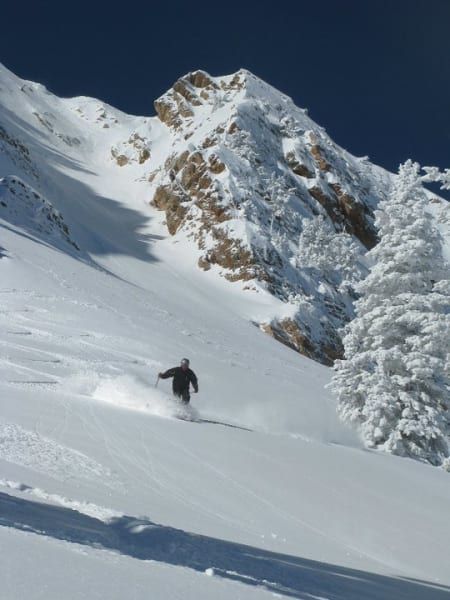 A person skiing down a snow covered mountain