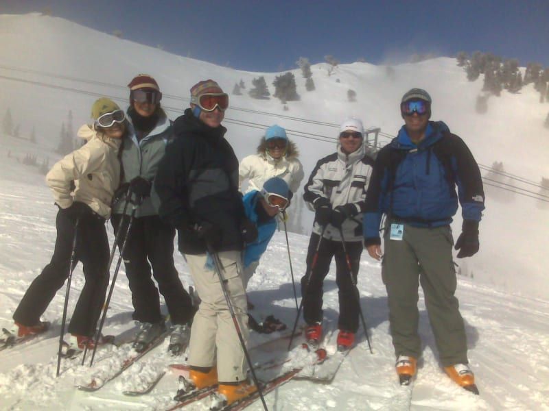 A group of people standing on top of a snow covered mountain