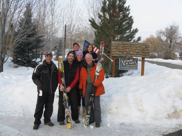A group of people are posing for a picture in the snow