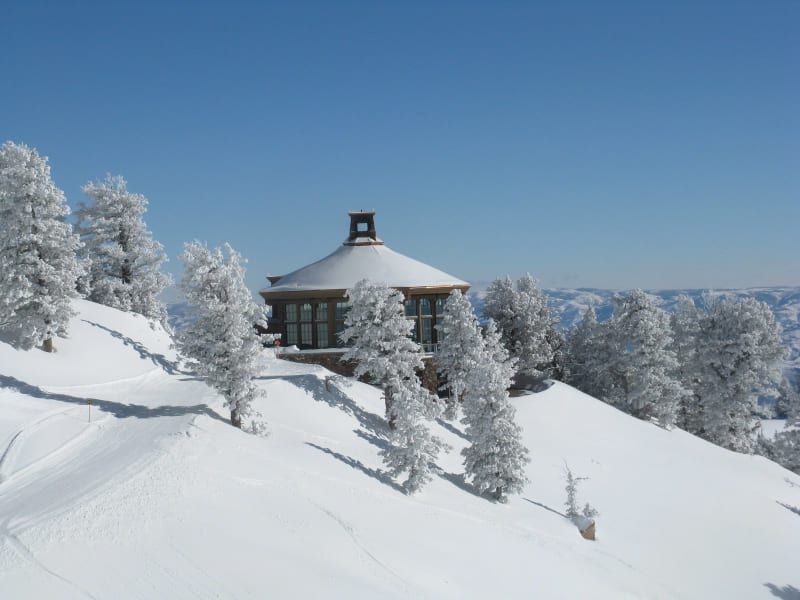 A snowy landscape with a small building in the middle