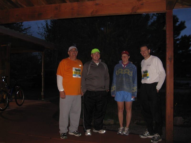 A group of people are posing for a picture under a covered area