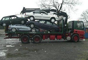 One of our lorries with scrap cars piled up on the back of it