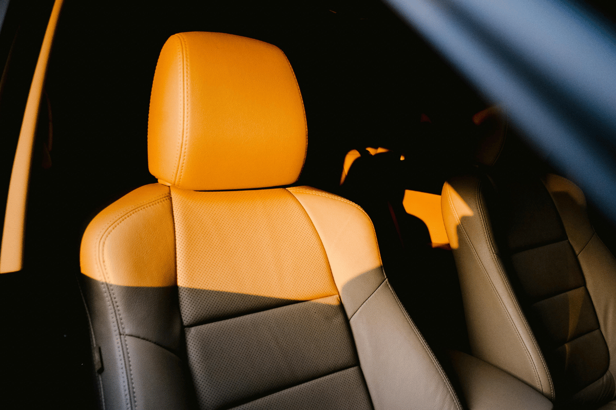 A white and black motorboat speeding across blue water, creating a wake.