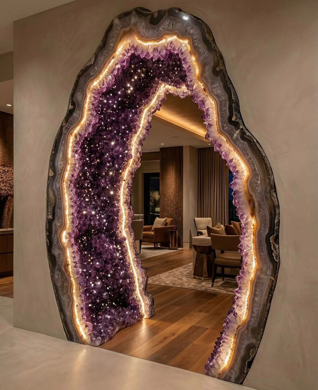 Large amethyst geode doorway with backlighting, opening to a room with wood floors and furniture.