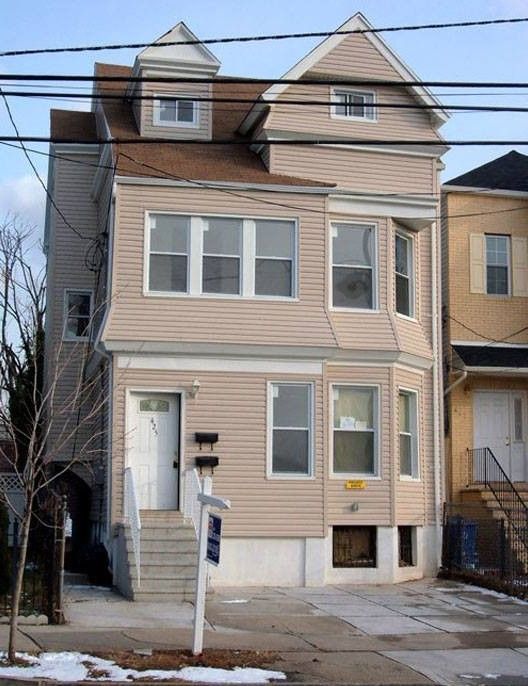 A house with a for sale sign in front of it