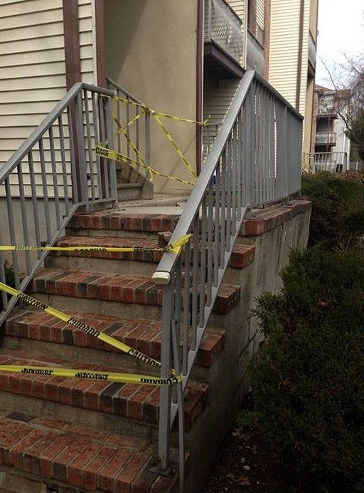 A set of stairs with yellow caution tape around them