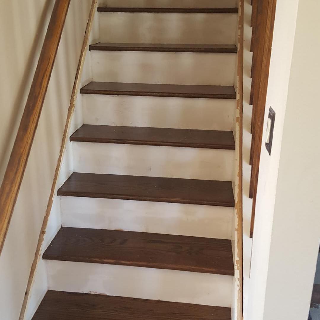 A set of stairs with wooden steps and a wooden railing.