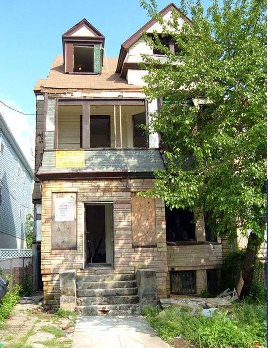 A house with a sign that says ' for sale ' on it