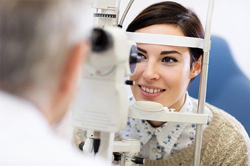 United States — Woman Looking In Ophthalmoscope