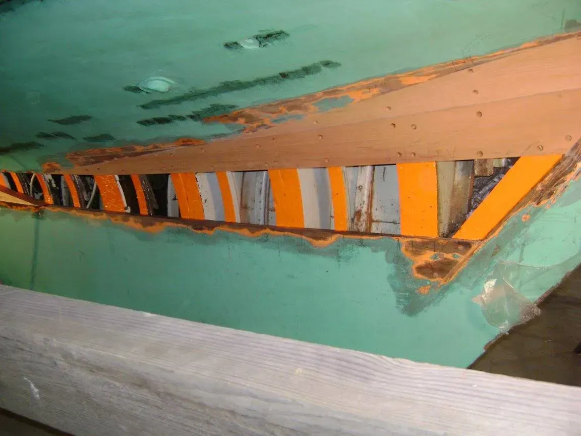 A green wall with a yellow and black stripe on it