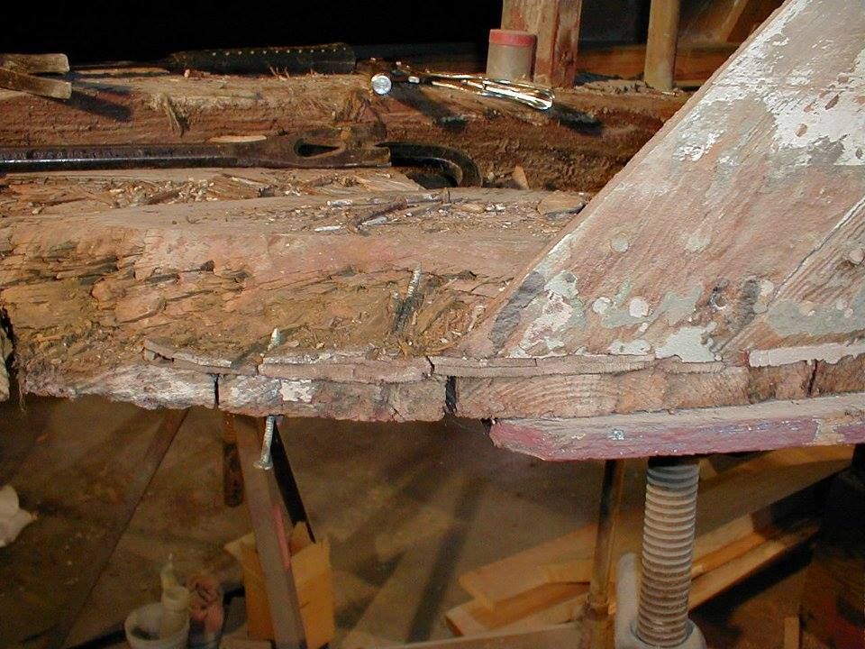 A piece of wood is sitting on a table with tools on it