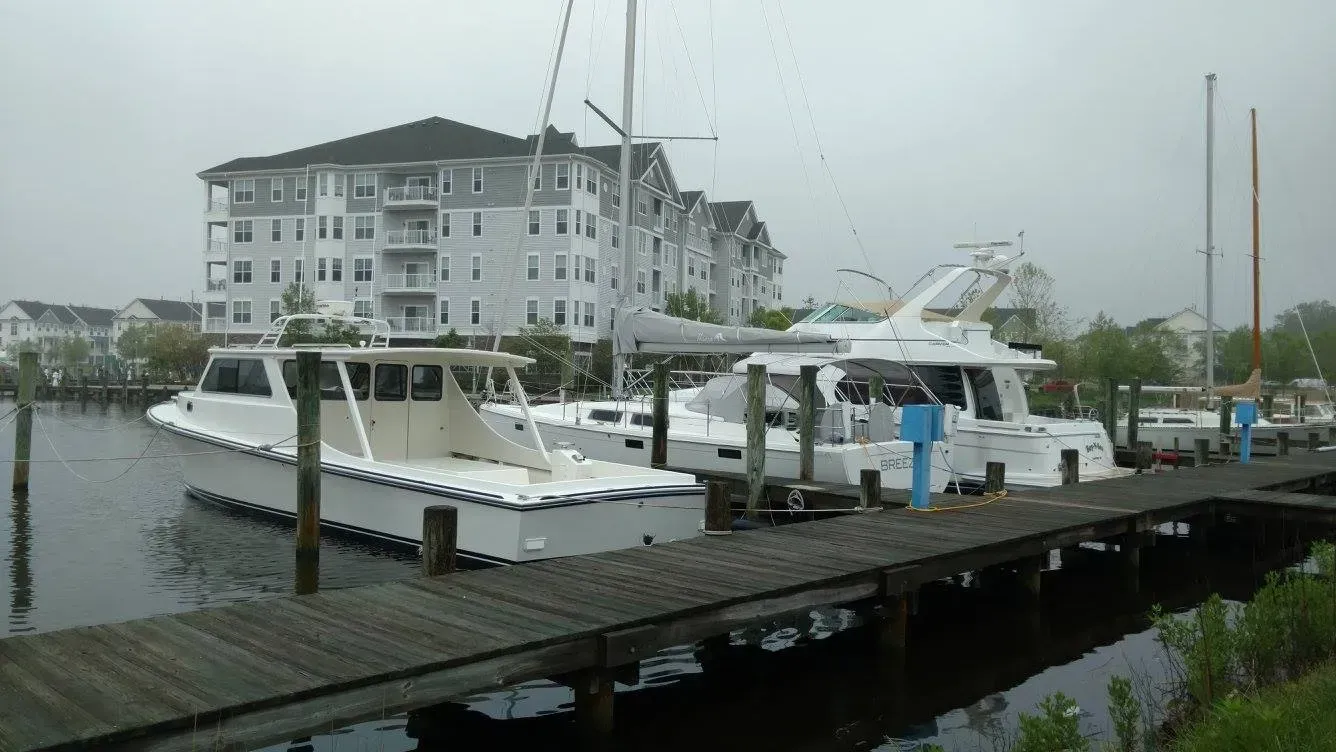 A dock with boats docked in front of a building