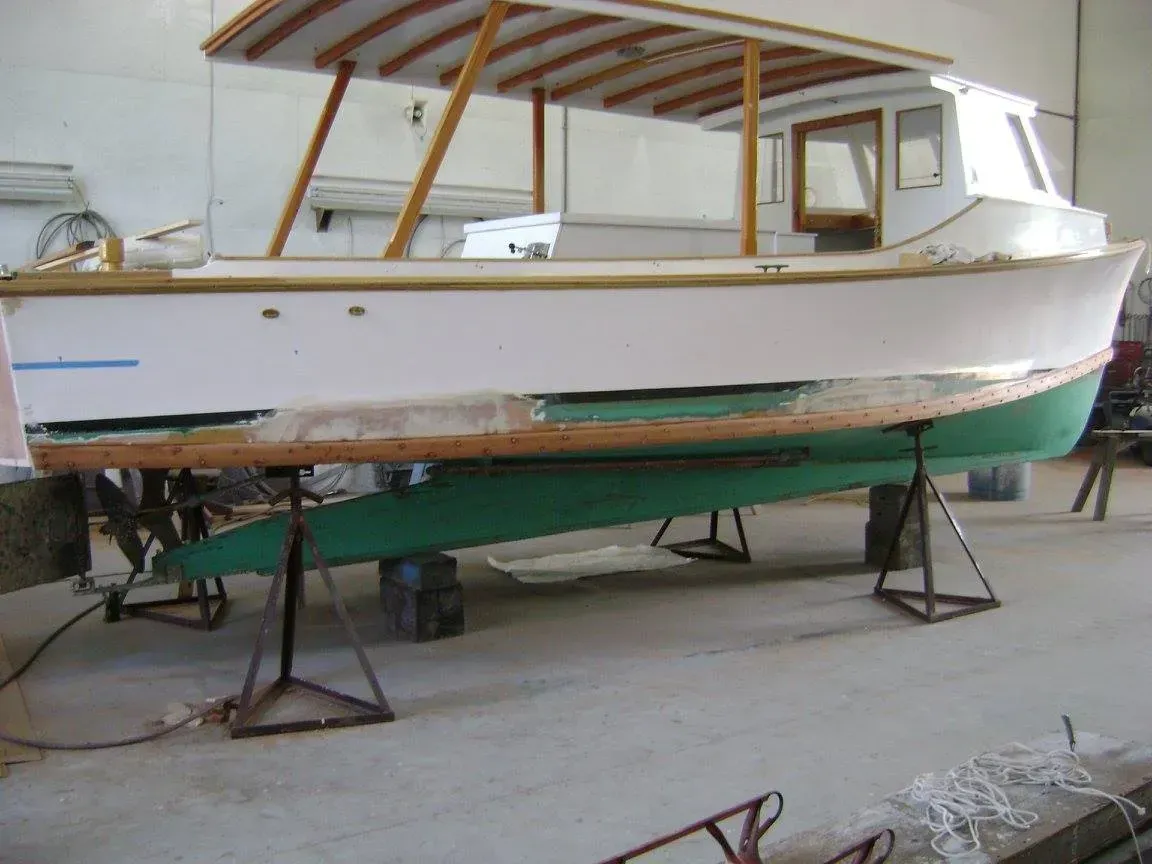 A white and green boat is sitting on a table