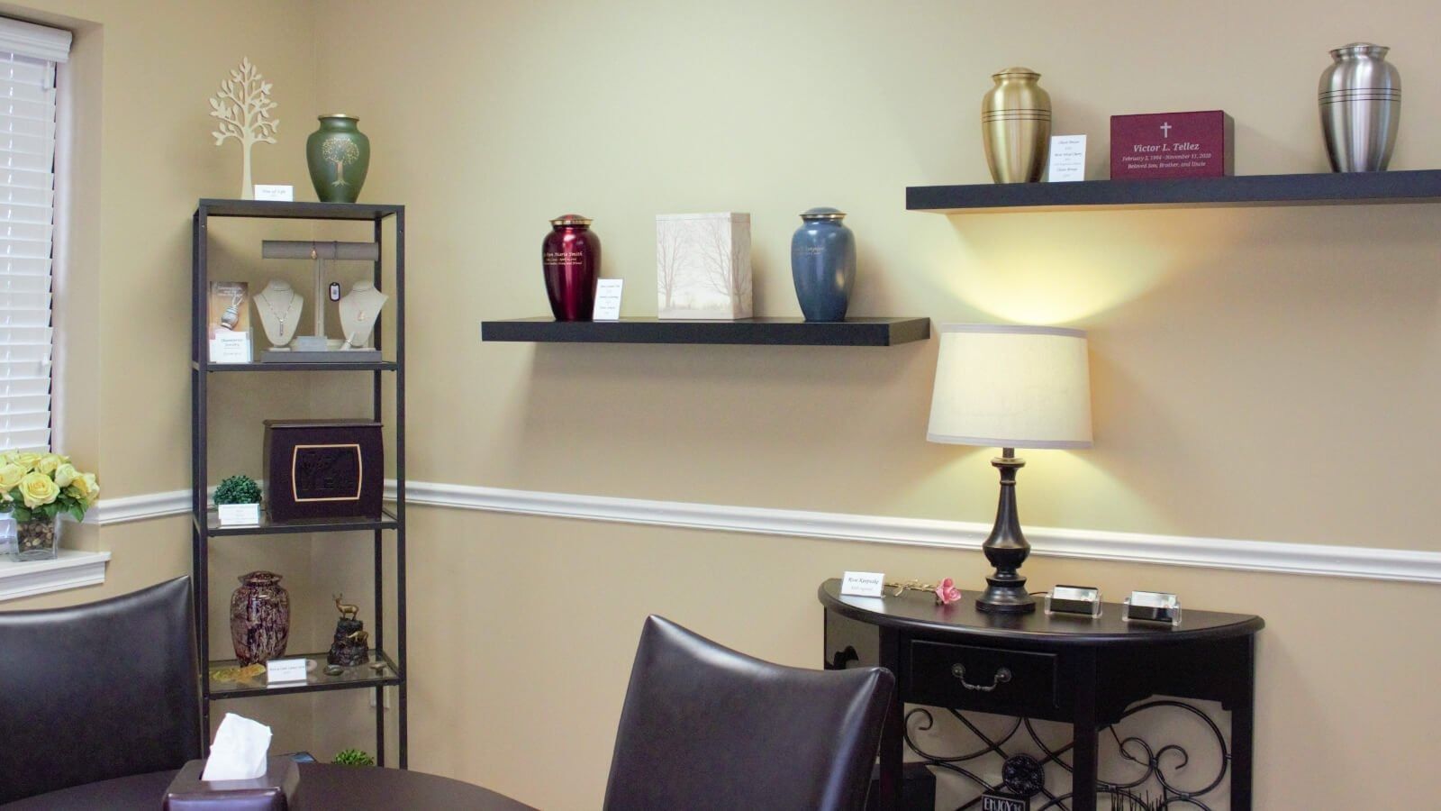 Cozy living room corner with wall shelves, decorative vases, a lamp, and a small side table
