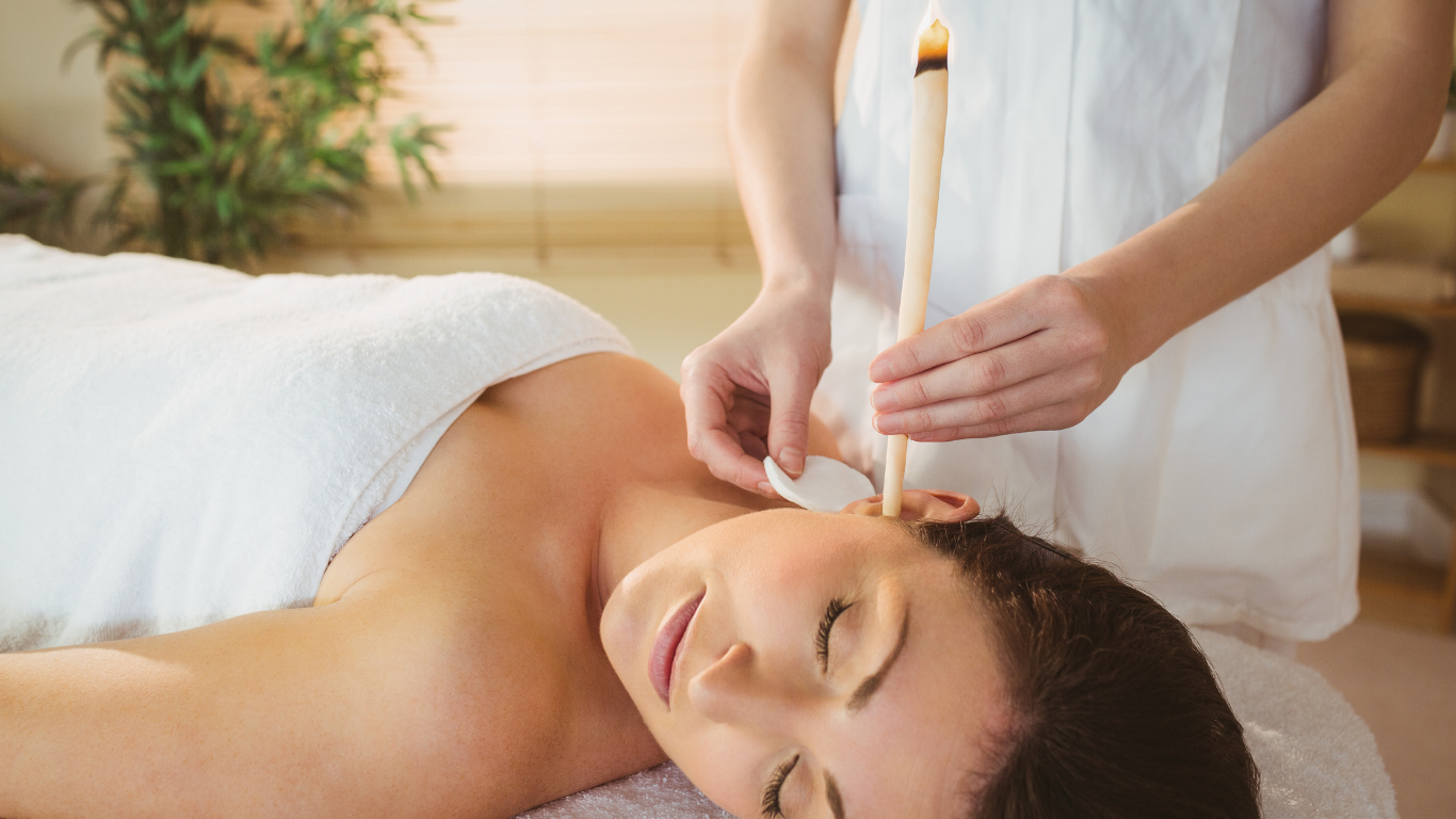 A woman is getting an ear wax treatment at a spa.