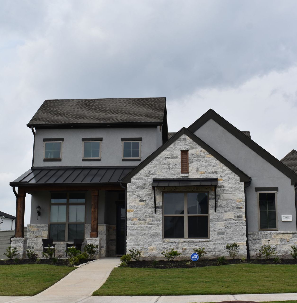 A large stone house with a black roof