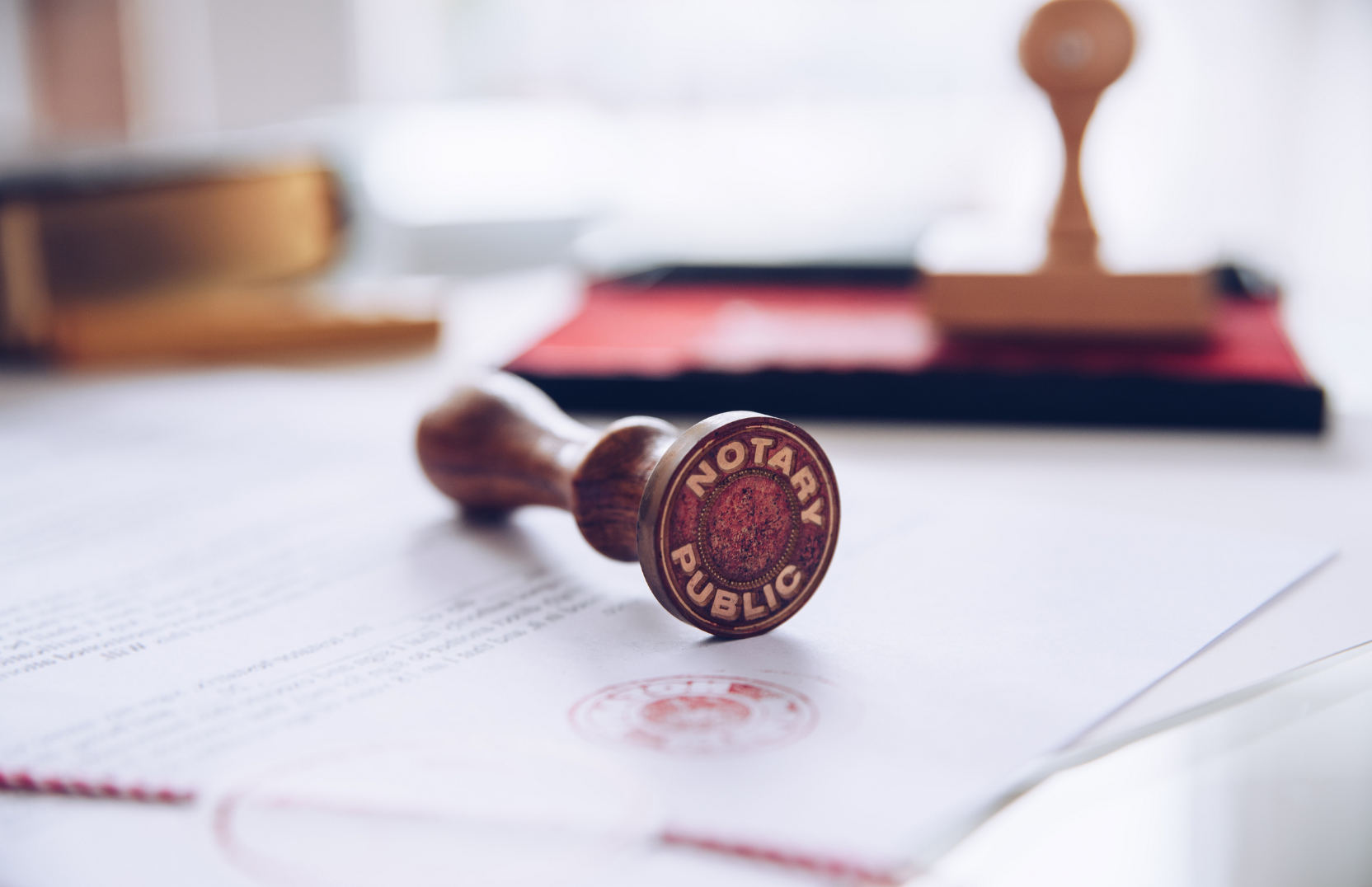 A wooden stamp is sitting on top of a piece of paper.