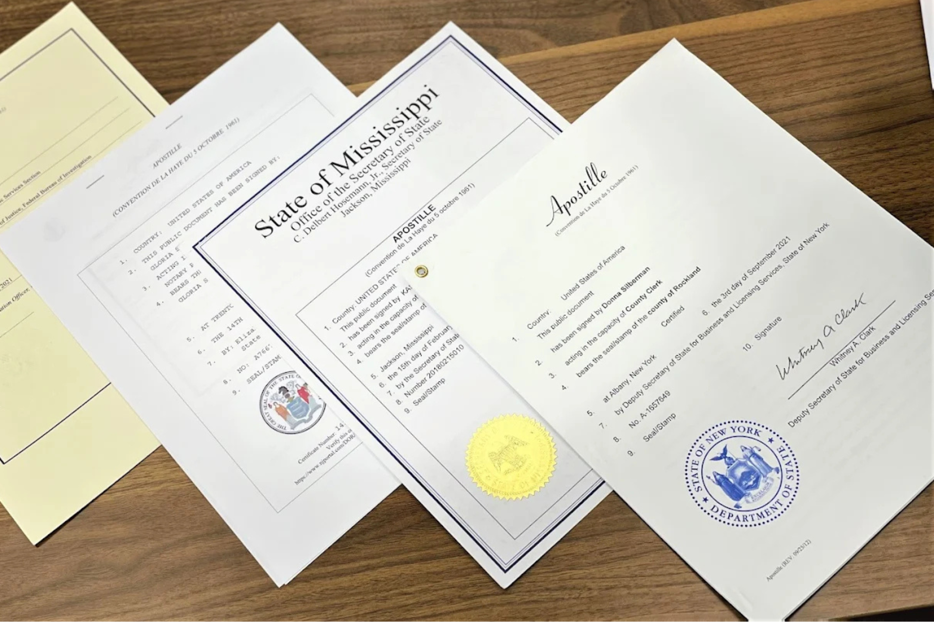 Three papers on a table one of which says state of mississippi