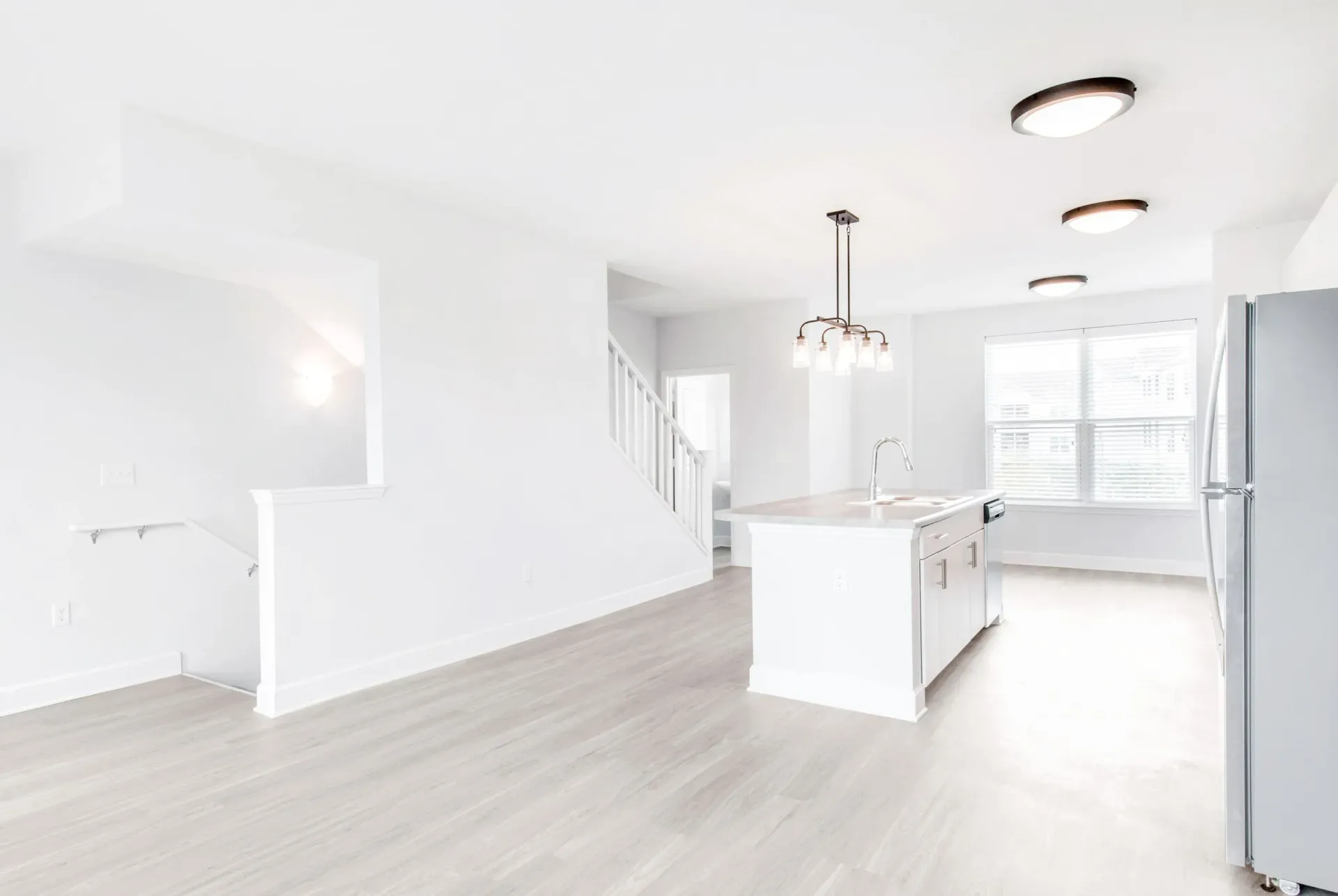 Bright open-concept kitchen in a modern apartment with an island and large window