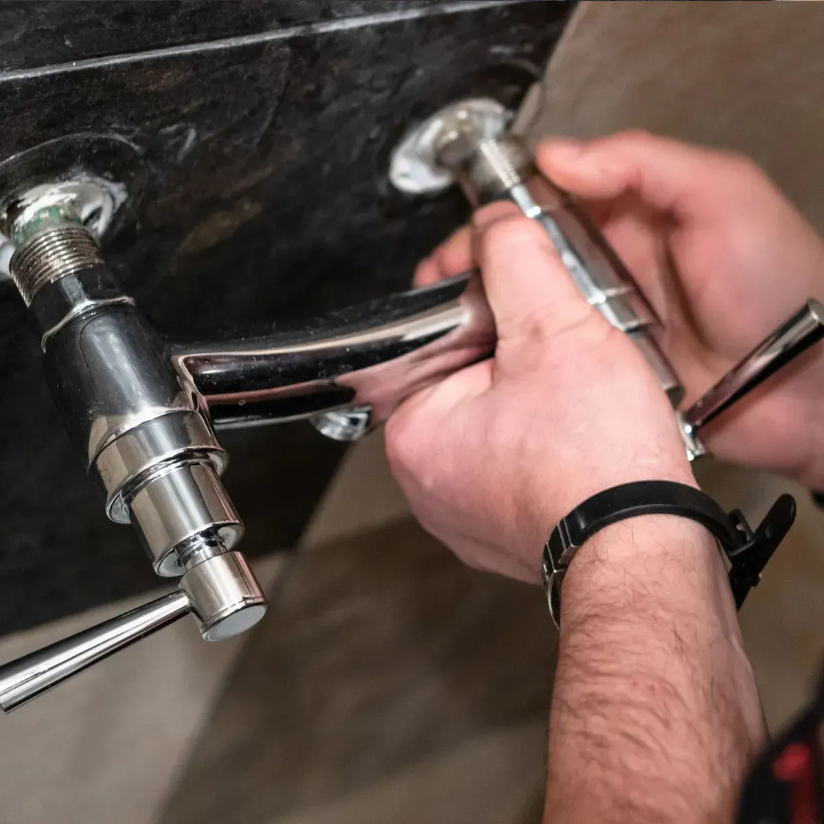 Plumber tightening connections on a new shower valve