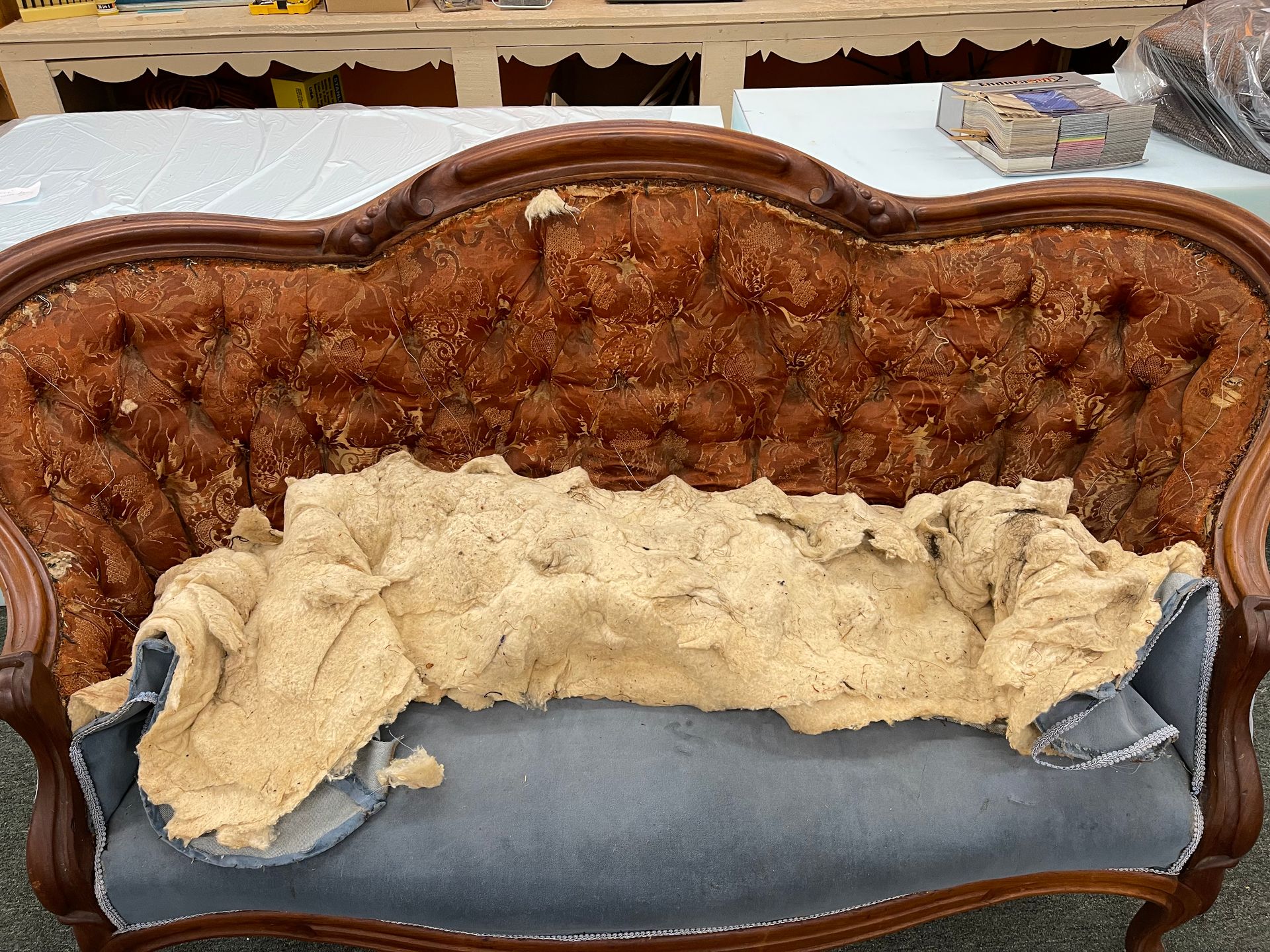 A couch with a lot of foam on it is sitting on a table.