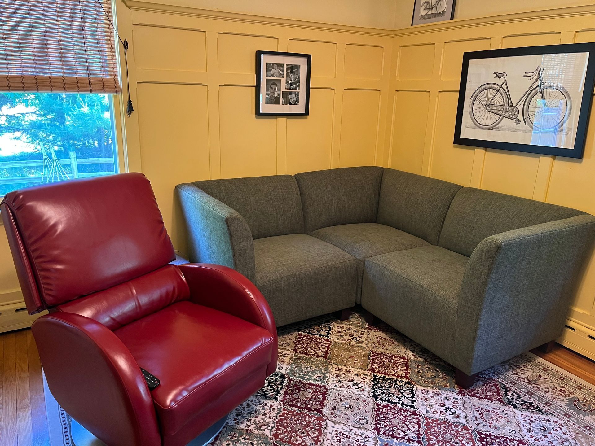 A living room with a couch , chair , and rug.