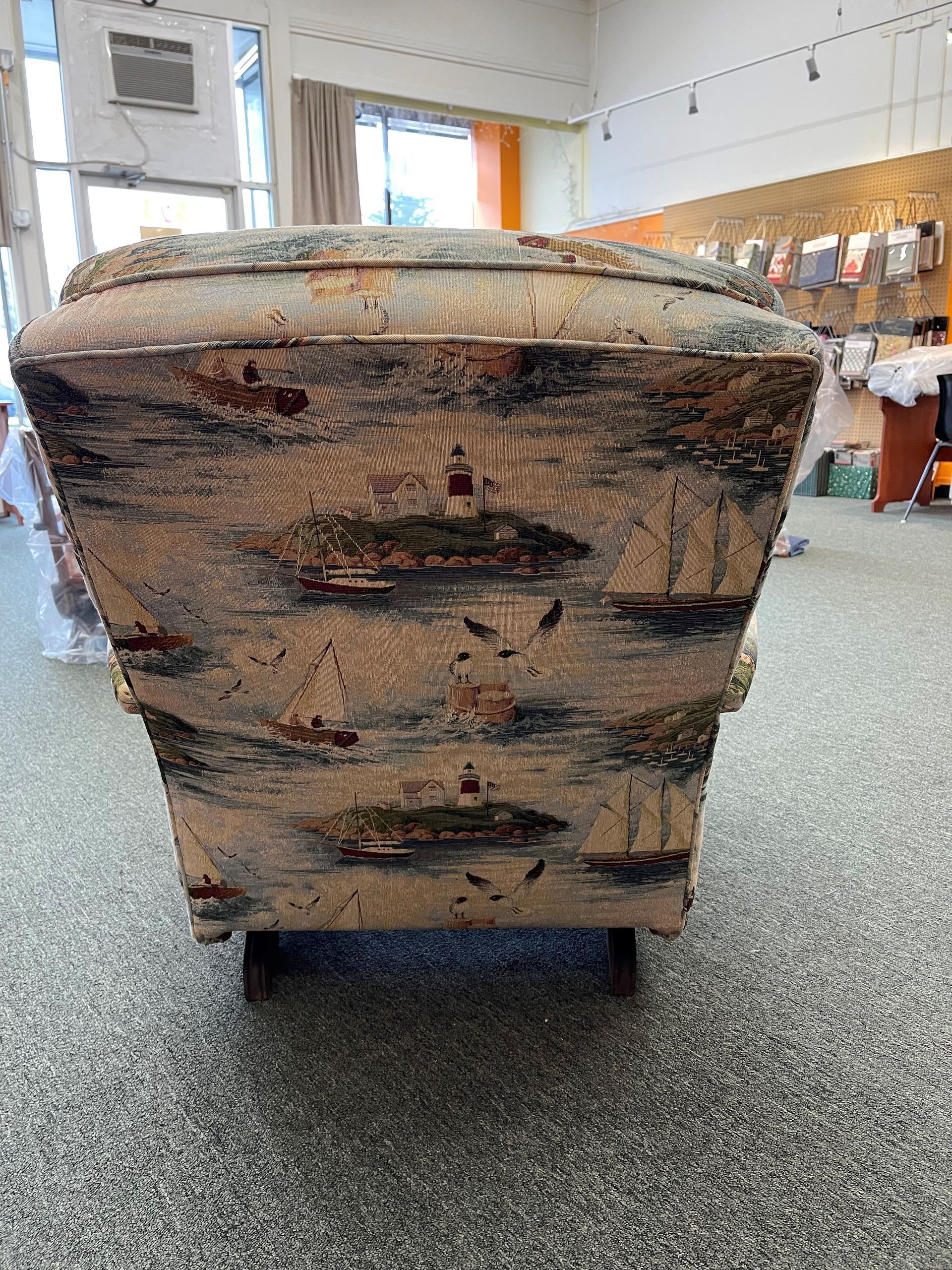A chair is sitting on a carpeted floor in a room.