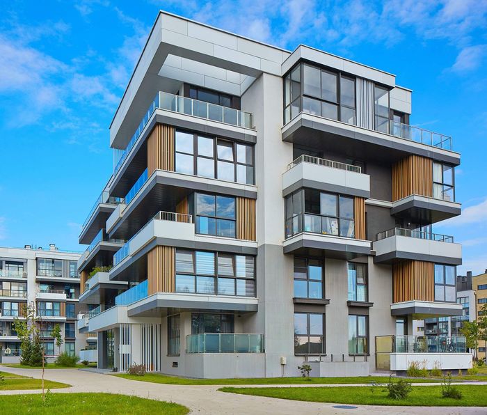 A large apartment building with a lot of windows and balconies.