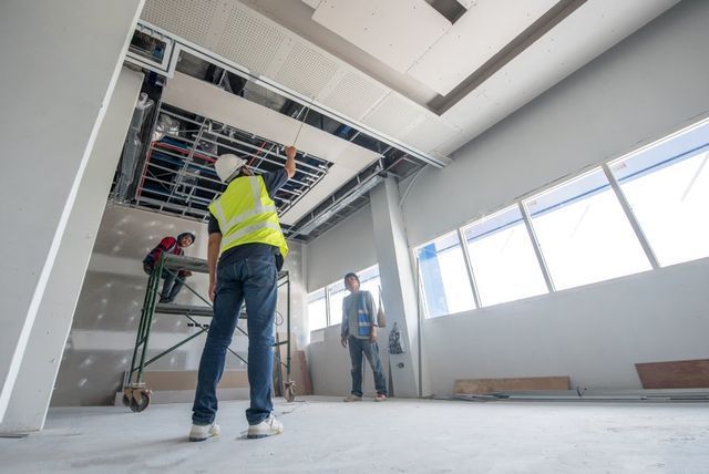 A group of construction workers are working on a building.