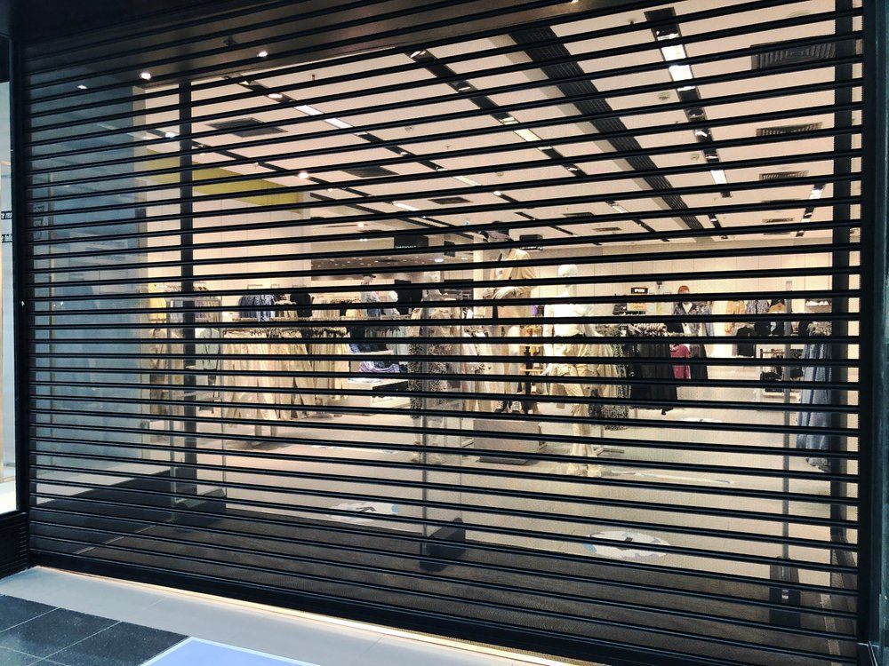 A store front with a roller shutter on it.