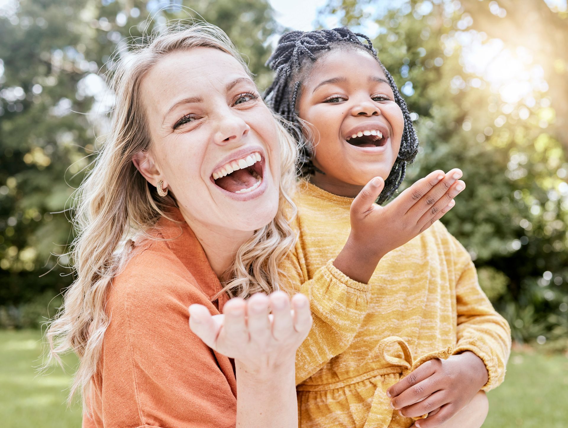 A woman is posing with a girl.