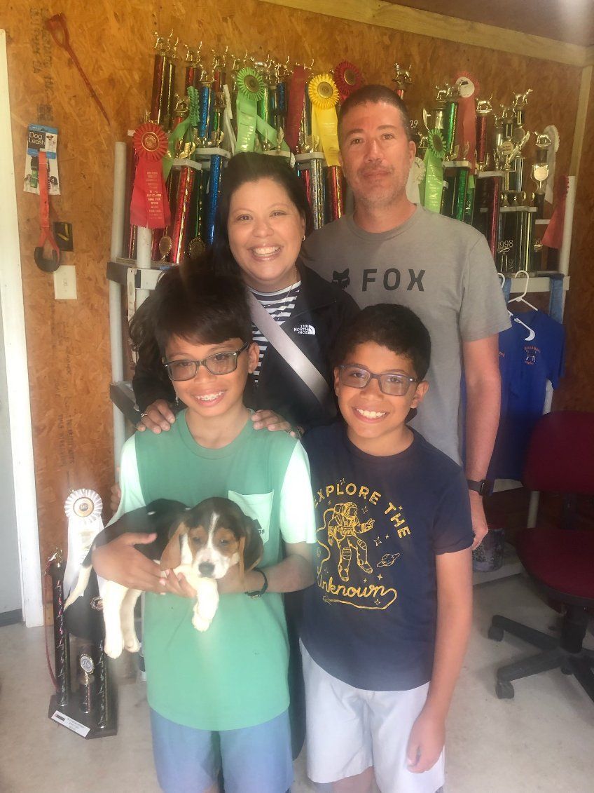 A family posing for a picture with a man wearing a fox shirt