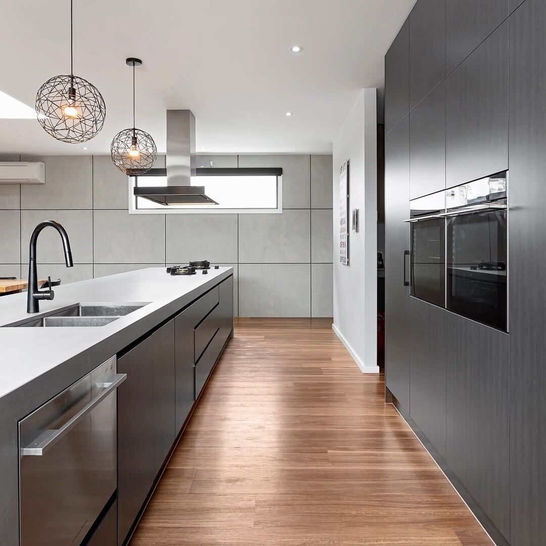 A Kitchen with Stainless Steel Appliances and Wooden Floors — Bootle Timber QLD Pty Ltd in Cairns, QLD