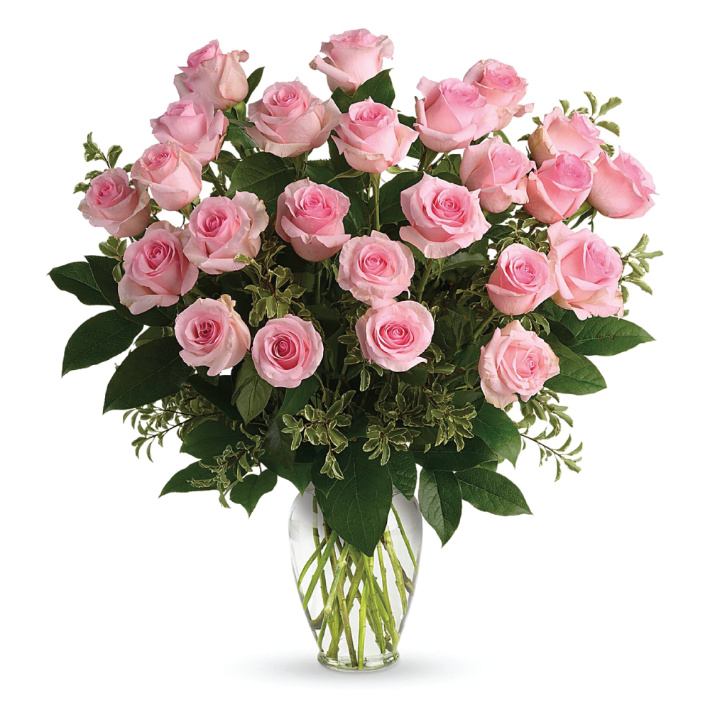 A vase filled with two dozen pink roses and greenery in a clear glass vase.
