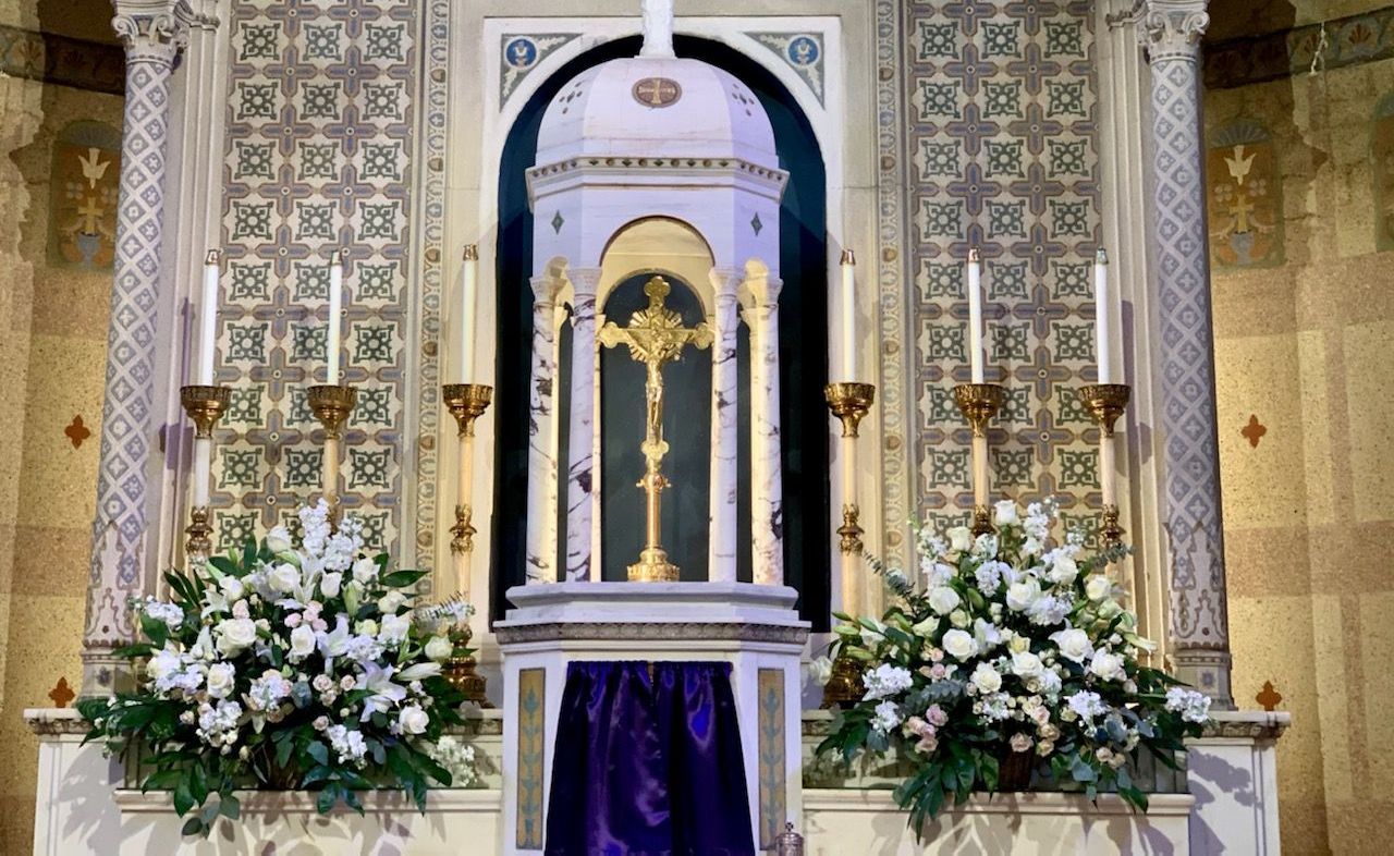 A church altar with flowers and candles on it