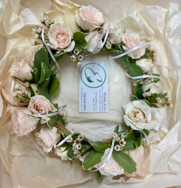 Floral wreath with blush roses and greenery in a white box, ribbon details, business card.