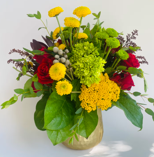 Pink orchid and kalanchoe plants in a pot, with pink and green foliage.
