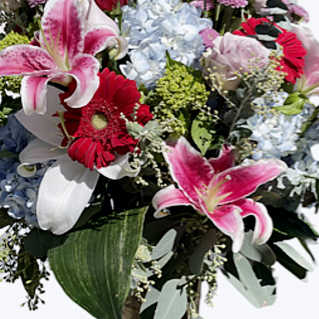 A tall metal vase filled with romantic flowers and premium florals.