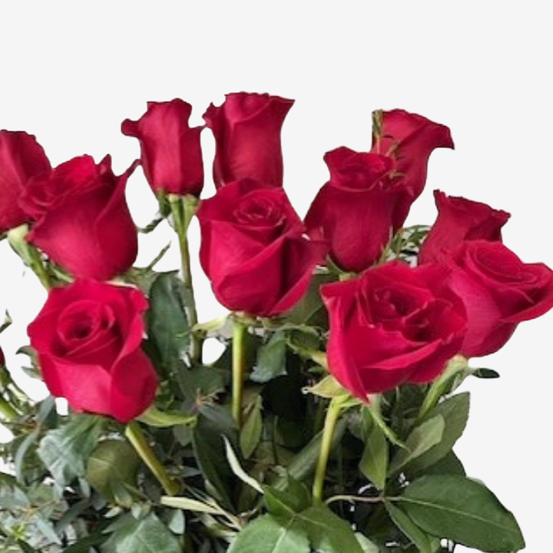 A beautiful bunch of roses with natural foliage arranged in a clear vessel.