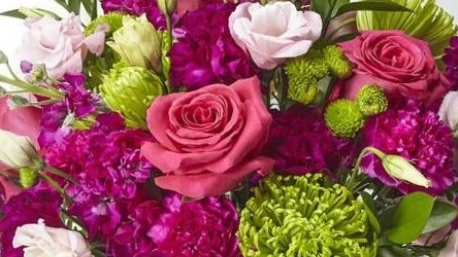 A close up of a bouquet of pink and green flowers.