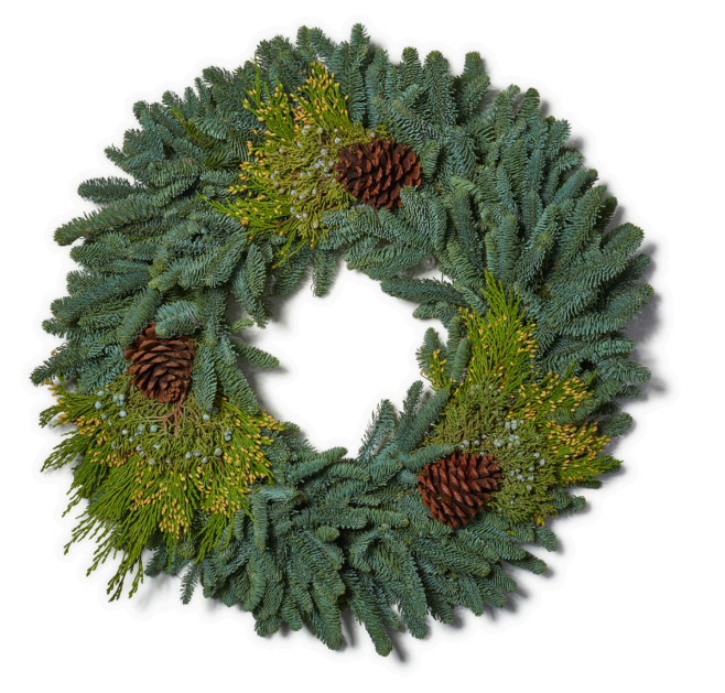 A Christmas deluxe wreath with pine cones and holiday evergreens ready fir holiday decorating.