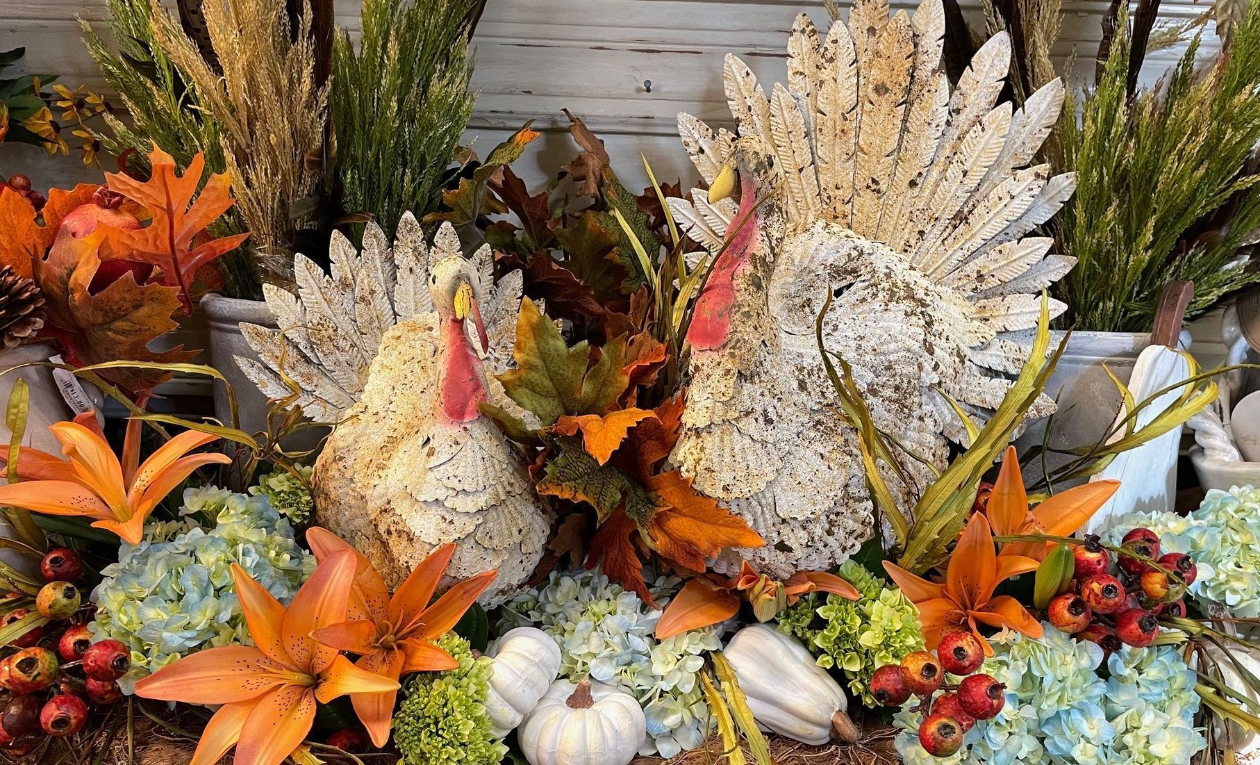 Two turkeys are standing next to each other on a wooden table.